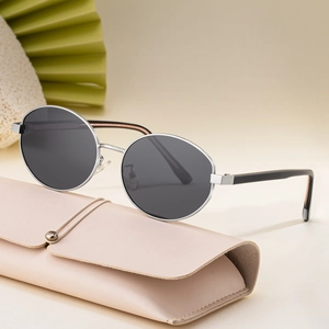 Retro oval polarized sunglasses with silver metal frames and beige leather storage pouch