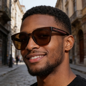 Outdoor shot of stylish square sunglasses with brown transparent frame and tinted lenses