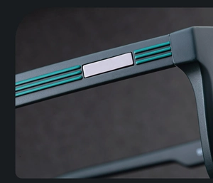 Close-up of matte black frame with green decorative lines and silver metal inlay detail