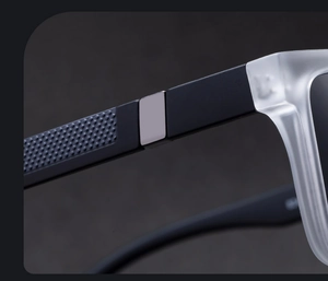 Detail of matte black temples with anti-slip texture and silver metal accents on square sunglasses