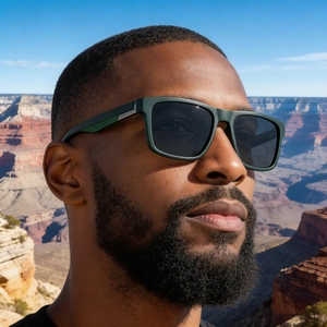 Close-up of green polarized sunglasses with textured carbon fiber style temples