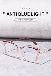 Detailed view of cat-eye anti-blue light glasses with gold metal frames and brown accents