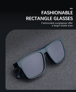 Detail of polarized rectangular sunglasses with a thick black frame on a grey felt texture