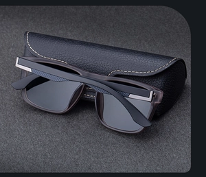 Close-up of polarized sunglasses with textured arms and a stitched leather case
