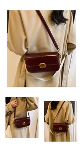 Detail of burgundy leather flap bag featuring a polished gold rectangular metal clasp