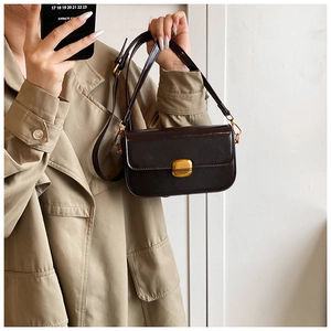 Détail du petit sac vintage café avec boucle en métal doré et finition lisse