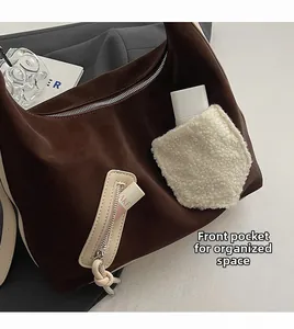 Close-up of the front fleece pocket and interior storage of the brown tote bag