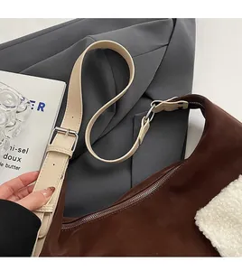 Detail of adjustable cream leather strap and brown suede texture with white faux fur trim