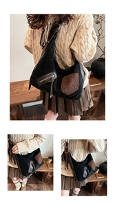 Detail view of large black suede hobo bag with brown plush patchwork and leather straps