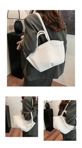 Close-up of white pebble grain leather shoulder bag with sleek curved silhouette