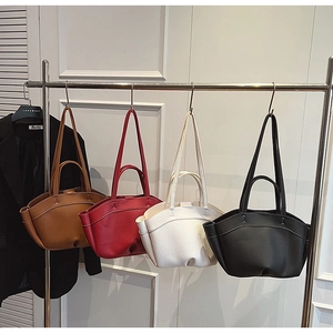Minimalist leather tote bags in four colors displayed on a rack for a premium look