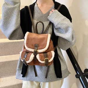 Vintage brown faux suede backpack with white shearling trim and drawstring closure