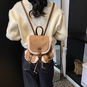 Vintage brown suede backpack with white faux shearling trim and drawstring closure