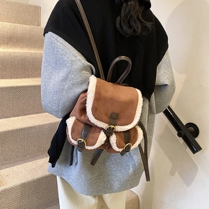 Brown faux suede backpack with white faux fur trim and adjustable leather straps