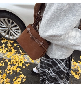 Brown frosted suede crossbody bag shown on model with fall gingko leaf background