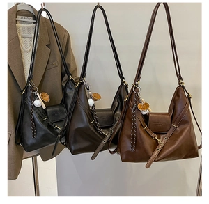 Three leather crescent Hobo bags in black and brown with baseball glove charms