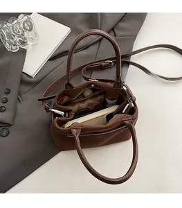 Internal view of brown crossbody bag showing spacious capacity and layered pockets