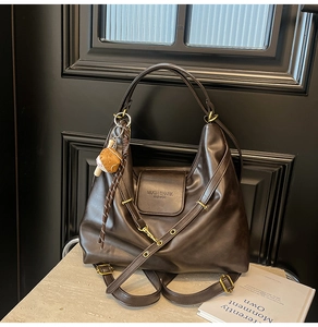 Detail view of large dark brown tote bag with premium leather texture and logo