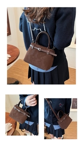 Detail view of brown matte leather shoulder bag showing strap and silver buckle closure