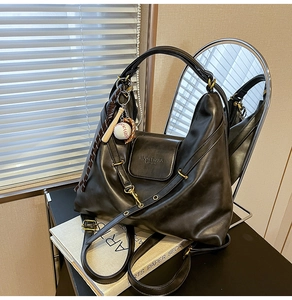 Detail of dark grey vintage tote with MUON SHARK logo and creative baseball keychain