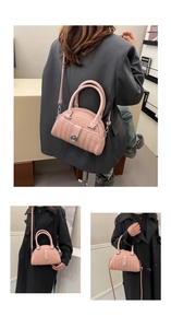 Macro shot of pink vertical quilted leather bag with silver buckle and crossbody strap