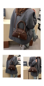 Detail of dark brown lychee textured leather bag with silver rotary lock and quilting