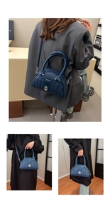 Detail of dark blue lychee grain leather handbag with vertical quilting and metal lock