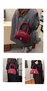 Detail of burgundy lychee leather bag with vertical quilting and silver droplet twist lock