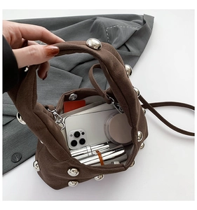 Top view of brown suede handbag interior showing capacity for phone and makeup