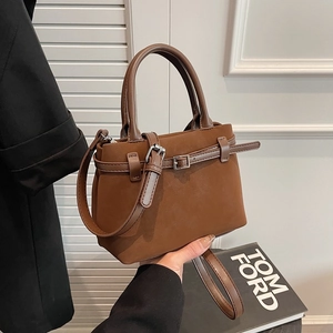 Retro dark brown crossbody tote bag with fine buckle straps and cylindrical handles