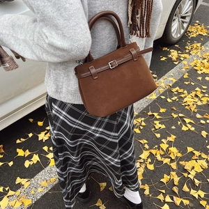 Retro brown suede handbag for women, minimalist vintage style shown in autumn setting