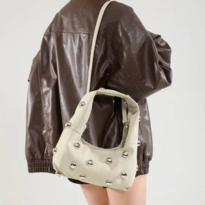 Retro cream shoulder bag with silver spherical studs on soft faux leather finish
