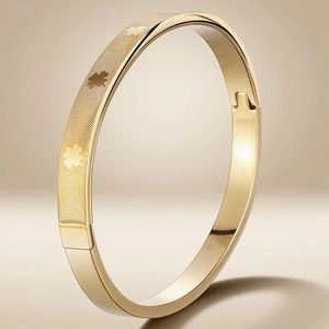 Titanium steel bangle with fingerprint texture and leaf relief details in golden finish