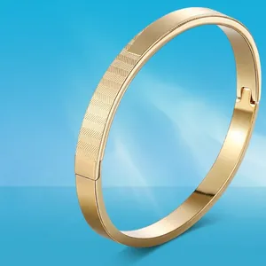 Titanium steel bangle with Forever Love engraving shown over splashing water ripples