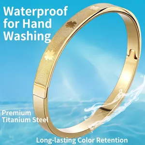 Gold plated stainless steel clover bangle with textured surface and snap closure design