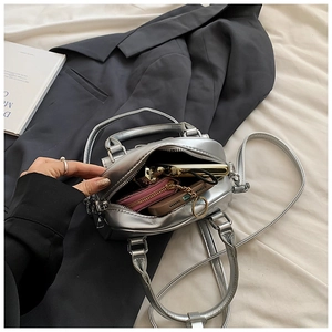 Interior view showing the capacity of this silver metallic Boston bag with daily items