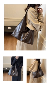 Detail of vintage brown tote bag showing asymmetrical stitching and soft leather texture
