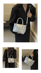 Detailed macro view of silver quilted bucket bag with woven texture and metal hardware