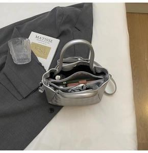 Silver quilted bucket bag interior showing spacious compartments and a central zip divider