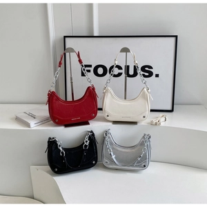 Detail of minimalist crescent underarm bags in red, white, black, and silver PU leather