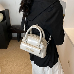 Creamy white glossy shell bag with chic bow decoration and adjustable shoulder strap