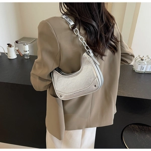 Silver crescent underarm bag with cracked texture and metallic chain detail