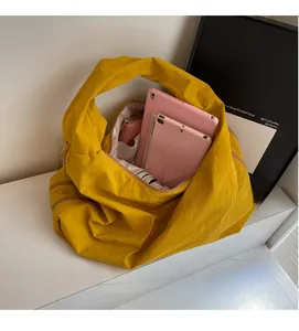 Spacious yellow nylon tote bag interior showing capacity for tablet and accessories