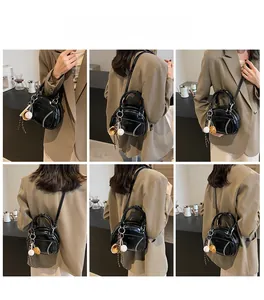 Detailed views of a black glossy bowling bag worn with a khaki suit from various angles