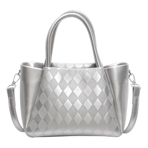 Quilted silver tote bag with dual handles and adjustable shoulder strap in minimalist style