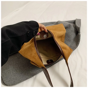 Detailed view of large tote bag interior with suede texture and magnetic closure