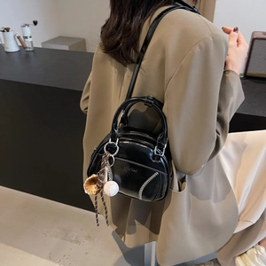 Retro black patent leather bowling bag with baseball stitching and charms for women