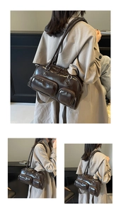 Detail of glossy dark brown shoulder bag featuring multiple functional front zip pockets