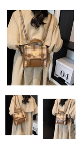 Dettaglio dello zaino vintage a quadri con toppa a orsetto e fibbie in pelle decorative