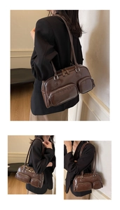 Detail view of dark brown oil wax leather shoulder bag with symmetrical zippers